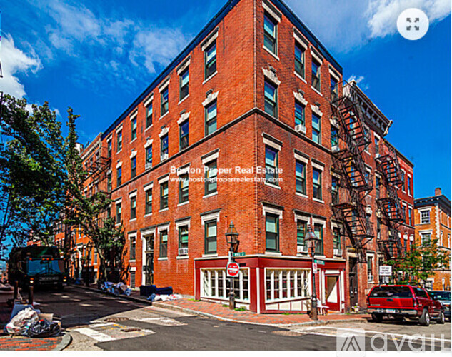 A red brick building with a fire escape on the side.