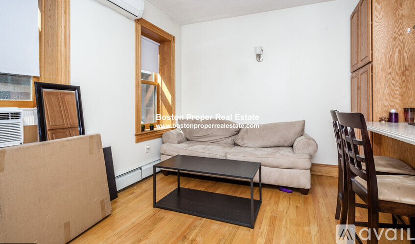 A living room with a couch, chair, and coffee table.
