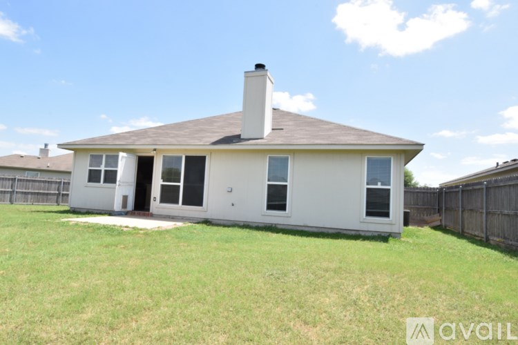 A white house with a brown roof and a chimney is available for sale.