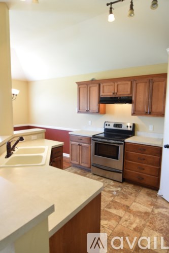A kitchen with a stove, oven, and sink.