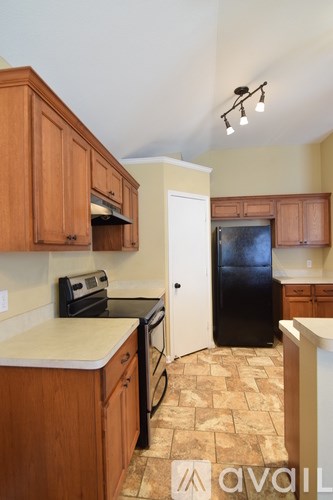 A living room with a fireplace and a ceiling fan.