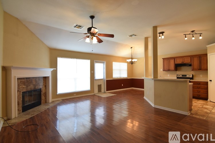A room with a ceiling fan and a window with blinds.