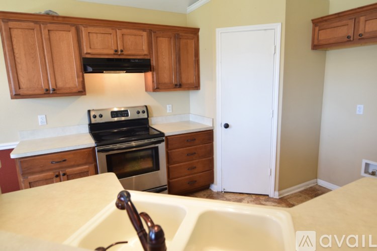 A kitchen with wooden cabinets and a white oven.
