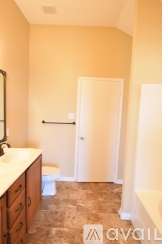 A bathroom with a toilet, sink, and a door.