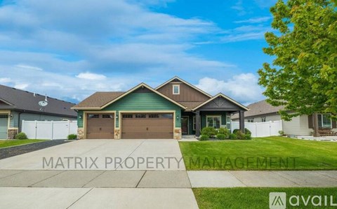 A house with a brown garage door is for sale.