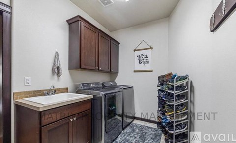 A kitchen with brown cabinets and a white sink.