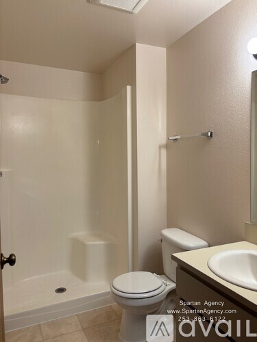 A bathroom with a toilet, sink, and bathtub.