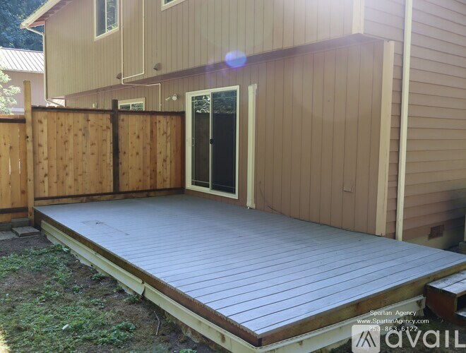A wooden deck in front of a house.