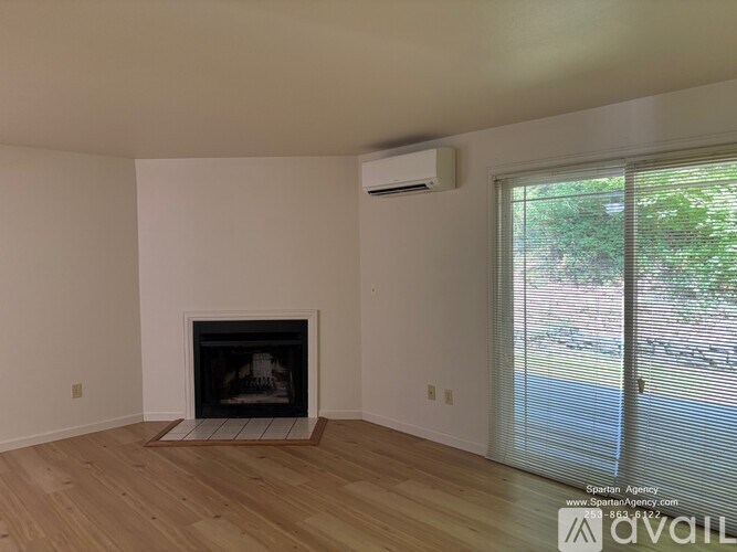 A room with a fireplace and sliding glass doors.