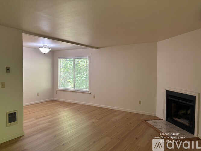 A room with a fireplace and a window.