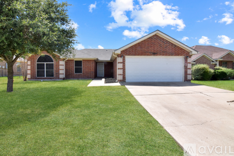 A red brick house with a white garage door.