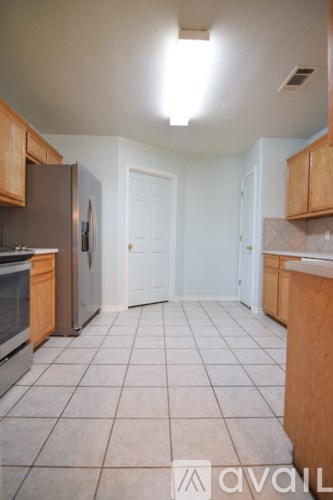 A kitchen with wooden cabinets and stainless steel appliances.