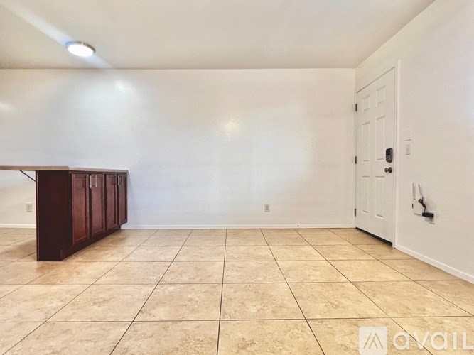 A room with a white door and a brown cabinet.