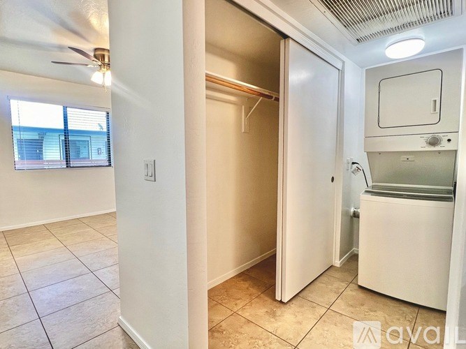 A small kitchen with a refrigerator, sink, and a window.