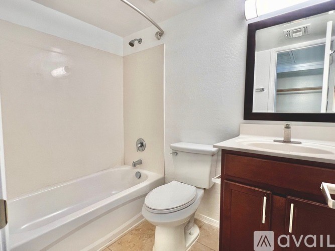 A bathroom with a toilet, sink, and bathtub.