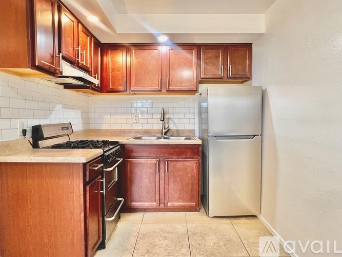 A kitchen with wooden cabinets and a white refrigerator.
