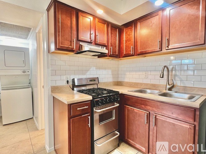 A kitchen with copper cabinets and a white fridge.