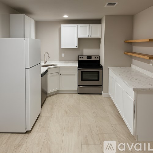 A kitchen with a white refrigerator, stove, and oven.