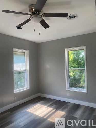 A hallway with carpeted floors and white doors.