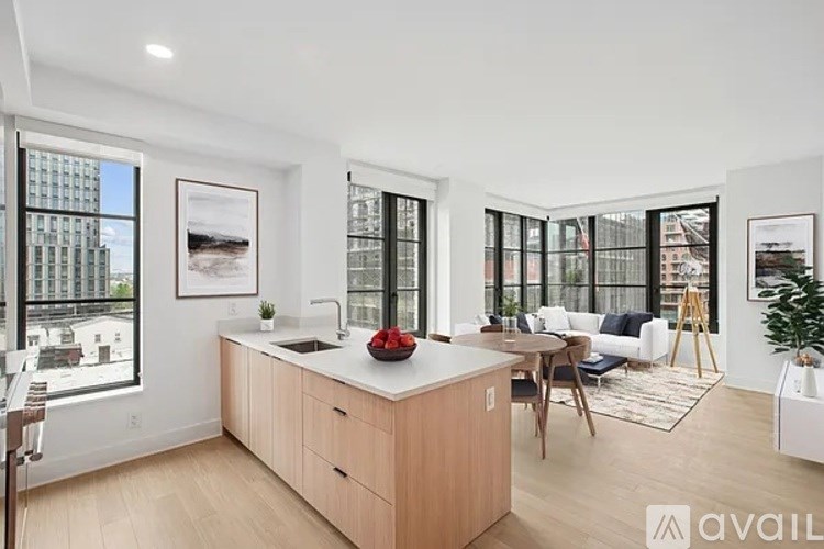 A modern kitchen with wooden cabinets and a large island in the middle.