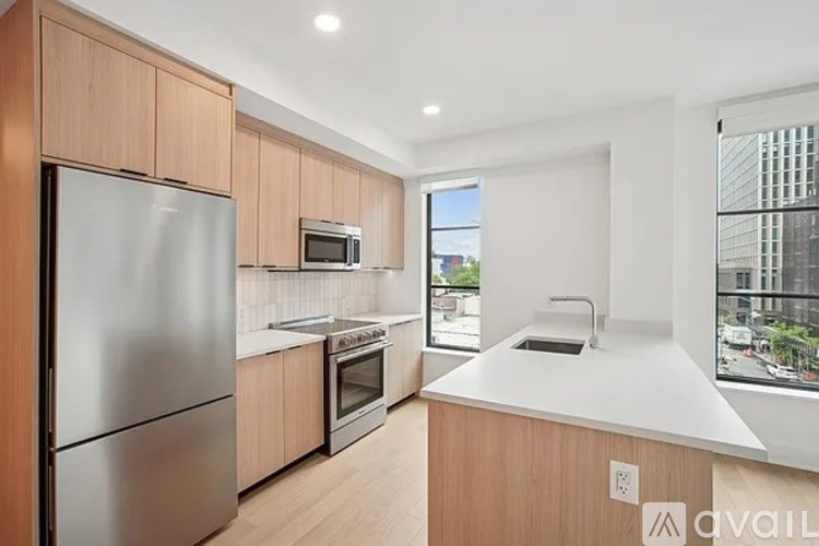A modern kitchen with wooden cabinets and stainless steel appliances.
