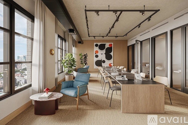 A modern office space with a blue chair and a coffee table.