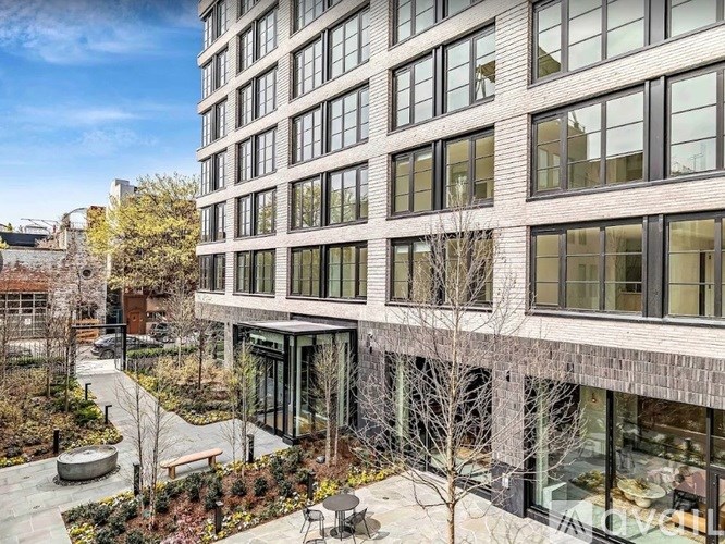 A modern building with a courtyard in front.
