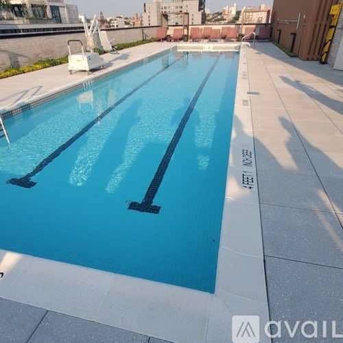 A swimming pool with the sun shining on it.