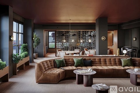 A modern living room with a brown sofa and a glass chandelier.