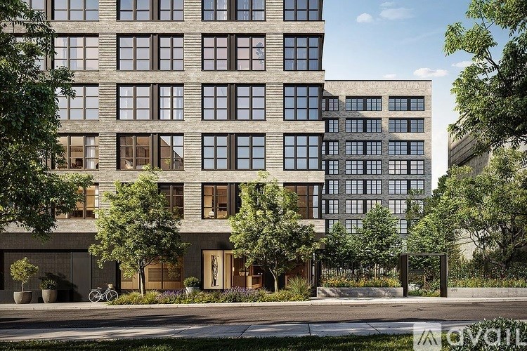 A modern multi-story building with a mix of glass and wooden panels.