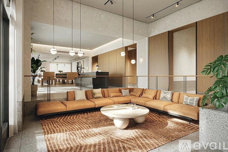 A modern living room with a large sectional sofa and a coffee table.