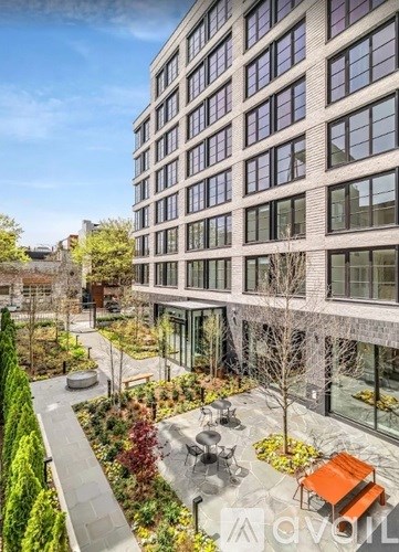 A modern building with a courtyard and seating area.