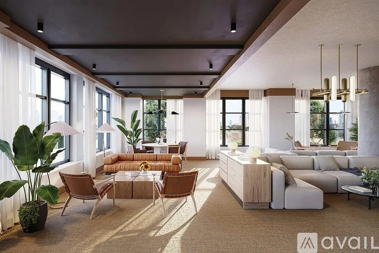 A modern living room with a large sectional sofa, a coffee table, and a large window with white curtains.