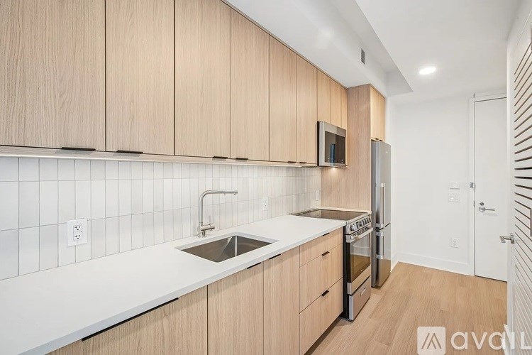 A kitchen with wooden cabinets and a white countertop.