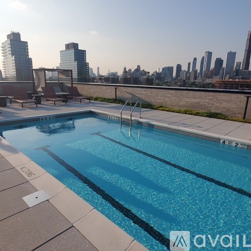 A swimming pool with a city skyline in the background.