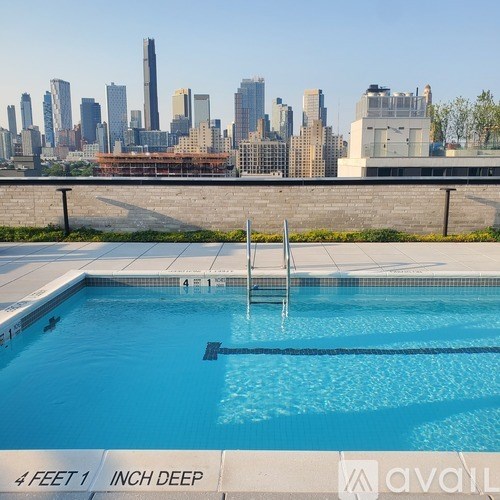 A pool with a city skyline in the background.