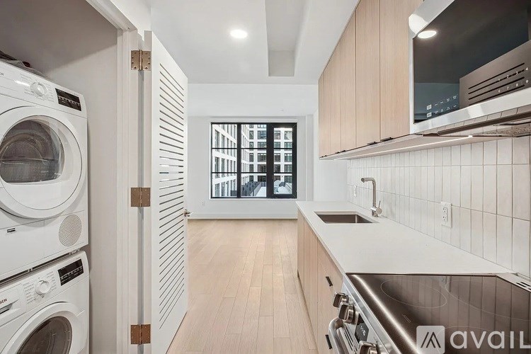 A modern kitchen with white appliances and wooden cabinets.
