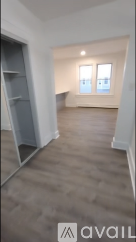 A room with a grey carpet and a grey shelving unit.