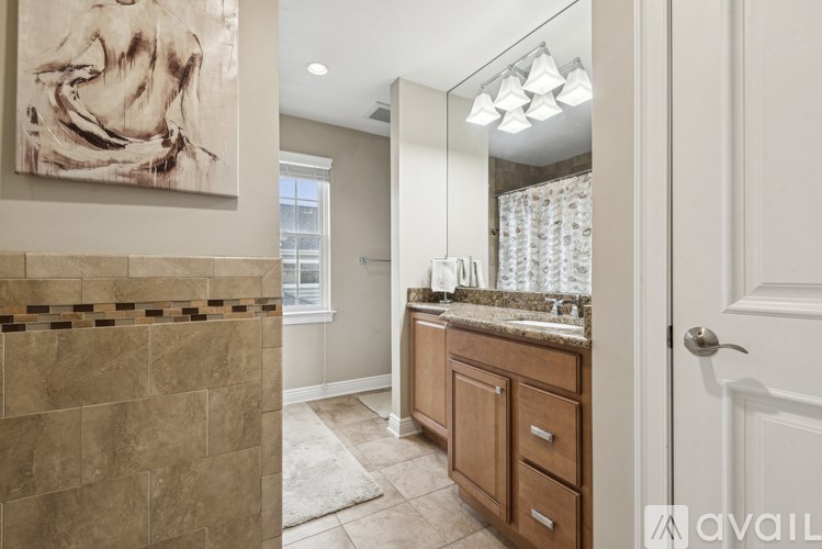 A bathroom with a tiled shower and a sink with a countertop.