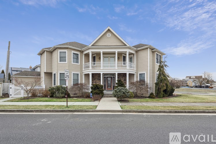 A house with a front yard and a sign that says "available" in the foreground.