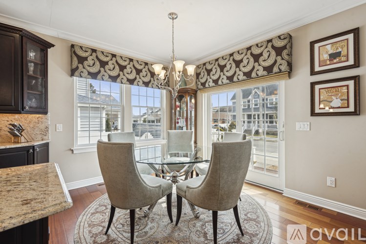 A dining room with a table and chairs.