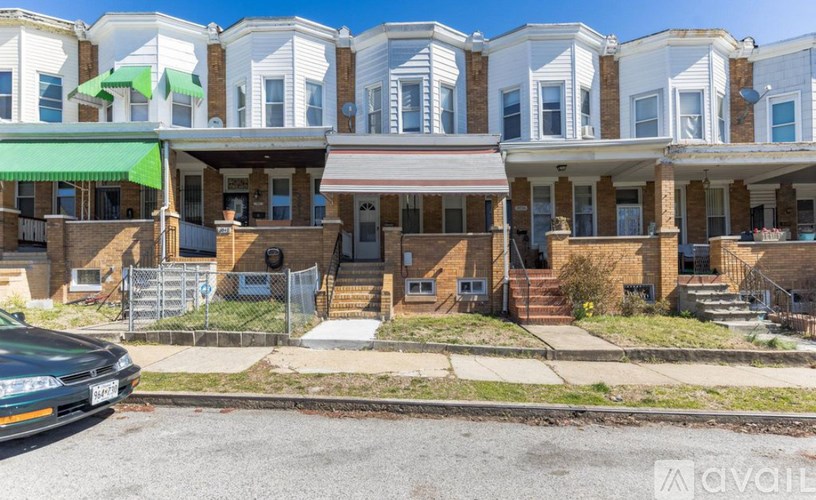 A row of houses with a car parked in front.