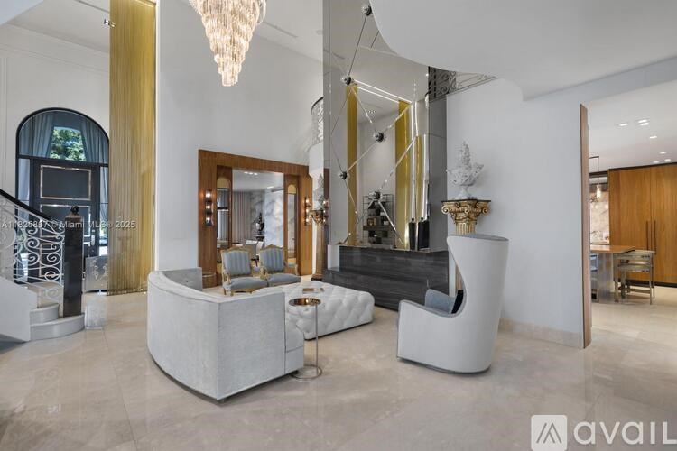 A modern living room with a large chandelier and a white sofa.