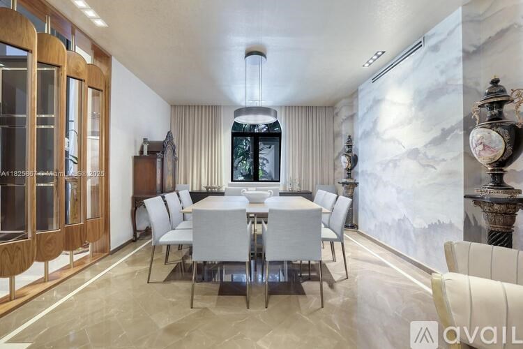 A dining room with a table set for six.