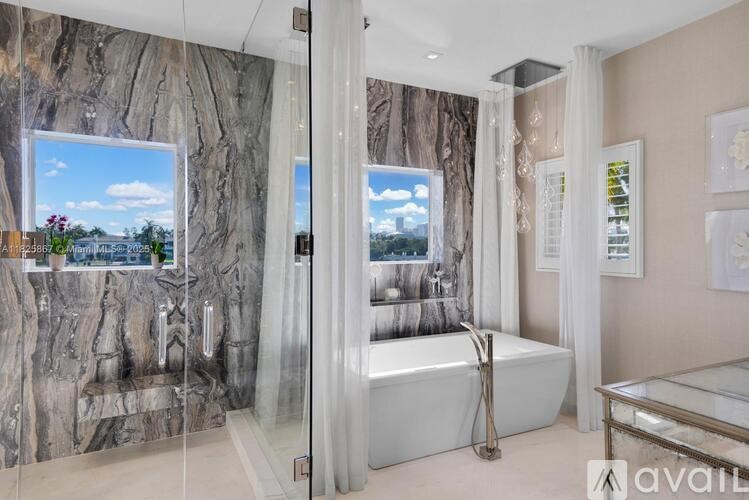 A bathroom with a large tub and a view of the outdoors through the window.