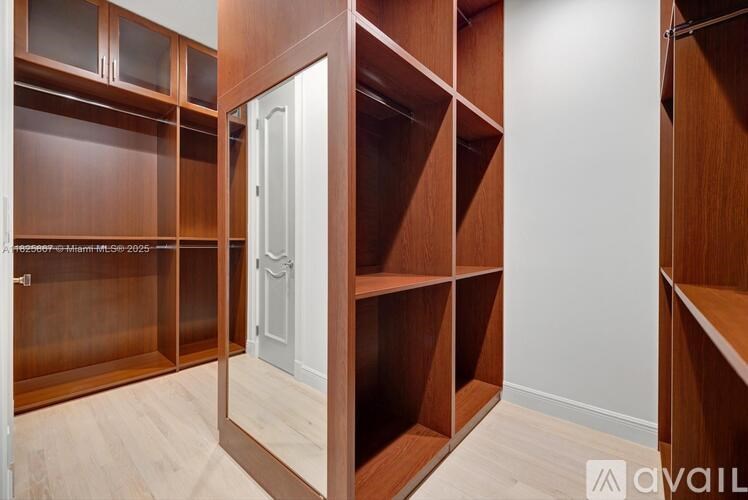 A room with wooden shelves and a white door.