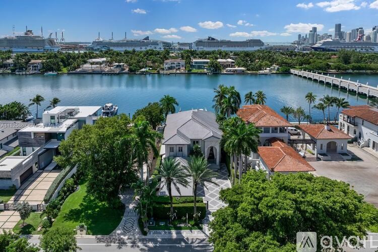 A view of a waterfront property with a large body of water and a city skyline in the distance.