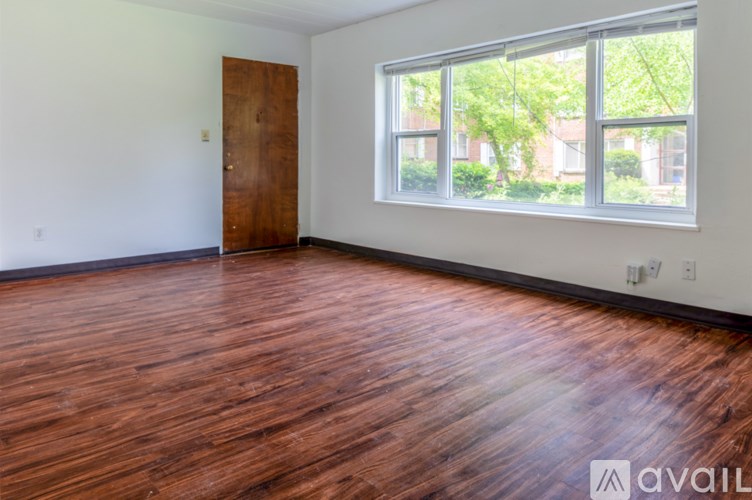 A room with a wooden floor and a large window.