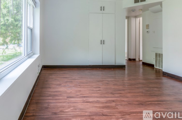 A room with wooden floors and white walls.