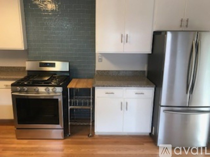 A kitchen with a stove, oven, and refrigerator.